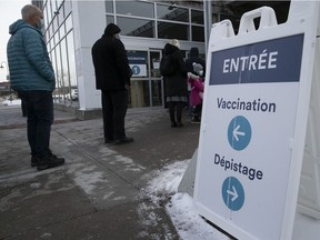 People line up for inoculations at the St-Laurent COVID-19 vaccination centre on Ste-Croix Blvd. on Monday.