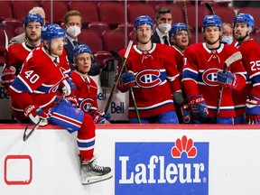Canadiens, from left, Jonathan Drouin, Joel Armia, Jesse Ylonen, Laurent Dauphin, Artturi Lehkonen, Jake Evans and Ryan Poehling watch the action from the bench during game against the Philadelphia Flyers in Montreal on Dec. 16, 2021.