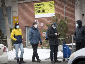 People stand in line at the Park Ave. COVID-19 testing clinic in Montreal on Dec. 30, 2021.