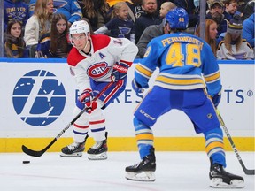 Nick Suzuki of the Montreal Canadiens controls the puck against the St. Louis Blues during the second period at Enterprise Center in St Louis on Dec. 11, 2021.