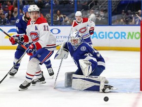 Lightning goalie Maxime Lagace makes a save behind Canadiens' Brendan Gallagher, in his usual spot in front of the net Tuesday night in Tampa.