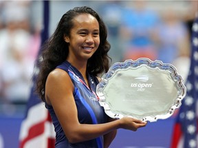 Laval's Leylah Annie Fernandez celebrates with the runner-up trophy after being defeated by Emma Raducanu of Britain at the U.S. Open in Flushing N.Y., on Sept. 11, 2021.