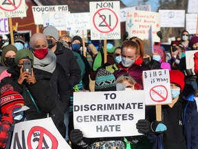 About 200 people gathered outside the office of Gatineau MNA Robert Bussière to protest against Quebec's secularism law.