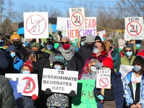 About 200 people gathered outside the office of Gatineau MNA Robert Bussière to protest Quebec's secularism law on Dec. 14, 2021.