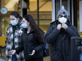 People keep their masks on as they leave the Concordia University EV building in Montreal Dec. 7, 2021.