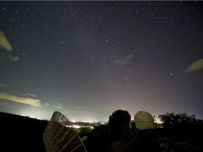 A meteor (top right) from the Geminids meteor shower enters the Earth's atmosphere, seen from the Prudencio Llach observatory near San Salvador in 2012.