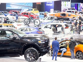 Spectators check out new vehicles at the Canadian International Auto Show in Toronto