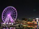 The Montreal Ferris wheel will be on display on April 4, 2020, in the tourist district of the Old Port, lit up in rainbow colors in support of the COVID-19 victims.