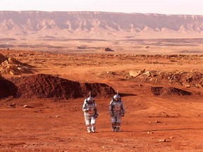 A couple of astronauts from a team from Europe and Israel walk in spacesuits during a training mission for Mars at a site that simulates an off-site station at the Ramon Crater in Mitzpe Ramon in Israel's southern Negev desert on Oct. 10, 2021. Six astronauts from Portugal, Spain, Germany, the Netherlands, Austria, and Israel will be cut off from the world for a month, from Oct. 4-31, only able leave their habitat in spacesuits as if they were on Mars. Their mission, the AMADEE-20 Mars simulation, will be carried out in a Martian terrestrial analog and directed by a dedicated Mission Support Centre in Austria, to conduct experiments ahead of future human and robotic Mars exploration missions.