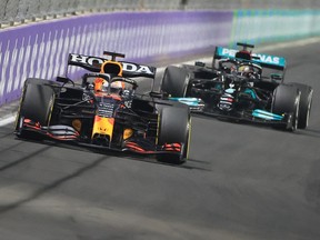 Red Bull's Dutch driver Max Verstappen, left, and Mercedes' British driver Lewis Hamilton compete in the Formula One Saudi Arabian Grand Prix at the Jeddah Corniche Circuit in Jeddah on Sunday, Dec. 5, 2021.