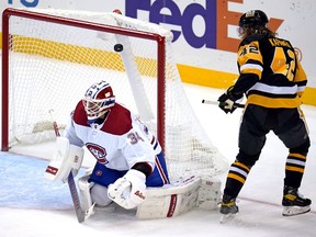Penguins' Kasperi Kapanen bats the puck over Canadiens goaltender Jake Allen for the first goal of the game Tuesday night in Pittsburgh.