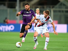 Fiorentina's Patrick Cutrone, left, and Bologna's Gabriele Corbo compete for the ball during a Serie A soccer match between Fiorentina and Bologna, at the Artemio Franchi stadium in Florence, Italy, Wednesday, July 29, 2020.