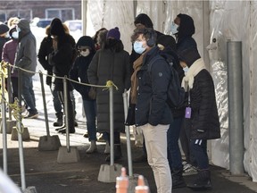 People line up at a COVID-19 testing site in Montreal on Wednesday, December 1, 2021.