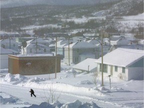 A student runs to school through the quiet, snowy streets of Murdochville in 2002.