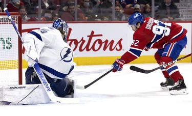 Montreal Canadiens left wing Jonathan Drouin (92) tries to tuck the puck in past Tampa Bay Lightning goaltender Andrei Vasilevskiy (88), but was stopped by Vasilevskiy during first period in Montreal, on Tuesday, Dec. 7, 2021.