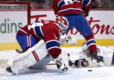 Tampa Bay Lightning right wing Corey Perry (10) watches as Montreal Canadiens goaltender Jake Allen (34) prepares to cover the puck during second period in Montreal on Tuesday, Dec. 7, 2021.