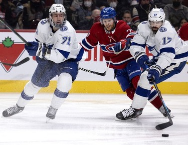 Montreal Canadiens defenseman Brett Kulak (77) tries to get between Tampa Bay Lightning centre Anthony Cirelli (71), right, and Tampa Bay Lightning left wing Alex Killorn (17) during second period in Montreal on Tuesday, Dec. 7, 2021.