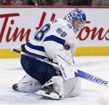 Tampa Bay Lightning goaltender Andrei Vasilevskiy (88) makes a blocker save against the Montreal Canadiens during third period in Montreal, on Tuesday, Dec. 7, 2021.