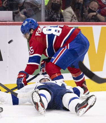 Montreal Canadiens left wing Mathieu Perreault (85) sees the puck sail past his face after checking a Tampa Bay Lightning to the ice during third period in Montreal, on Tuesday, Dec. 7, 2021.