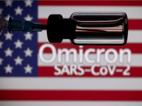 A vial and a syringe are seen in front of a displayed United States' flag in this illustration taken Nov. 27, 2021.