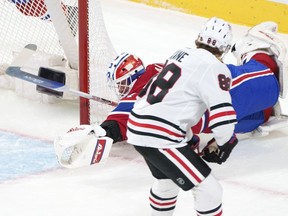 Canadiens' Jake Allen makes a desperation save on Blackhawks' Patrick Kane during the first period moments after the netminder carelessly gave the puck away.