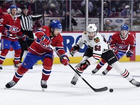 Montreal Canadiens defenseman Kale Clague plays the puck while Chicago Blackhawks forward Reese Johnson forechecks during game at the Bell Centre on Dec. 9, 2021.