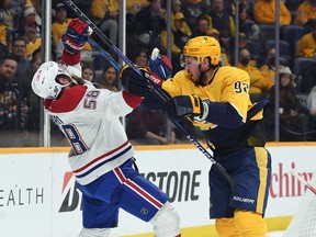 Predators' Ryan Johansen (92) is called for a high stick after a hit on Canadiens' David Savard (58) during the first period at Bridgestone Arena on Saturday, Dec. 4, 2021, in Nashville.