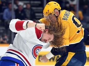 Dec 4, 2021; Nashville, Tennessee, USA; Montreal Canadiens left wing Michael Pezzetta (55) and Nashville Predators defenseman Mark Borowiecki (90) fight during the second period at Bridgestone Arena. Mandatory Credit: Christopher Hanewinckel-USA TODAY Sports