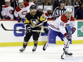Canadiens' Jesse Ylönen moves the puck past Penguins defenceman Kris Letang during the third period in Pittsburgh Tuesday night. Ylönen scored his first NHL goal in the second period during Montreal's 5-2 loss.