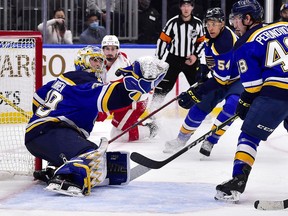 St. Louis Blues goaltender Charlie Lindgren defends the net against a shot by Detroit Red Wings' Dylan Larkin (71) during the third period at Enterprise Center in St. Louis on Dec. 9, 2021.
