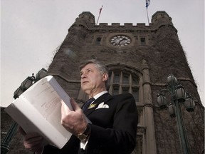 Mayor Peter Trent of Westmount, seen here in 2000 holding the text of Bill 170 as enacted, was one of the mergers' foremost opponents.