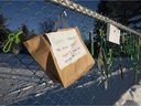 Signs and ribbons are seen on a fence outside an elementary school protesting Quebec Bill 21 and the absence of a teacher, Thursday, Dec. 9, 2021 in Chelsea, Quebec.