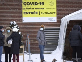 People wait in line at a Parc Ave. COVID-19 testing site in Montreal, on Monday, January 3, 2022.