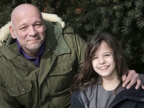 Sam Kuhn and his daughter Simone outside their home on Wednesday. Simone is in Grade 4 at Ècole Lucien-Guilbault, a private French-language school in the public interest for children with learning disabilities, and is thriving.