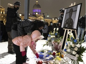 Riley Valcin's niece lays flowers during a vigil for him on Wednesday, Jan. 5. Valcin was killed in a workplace accident at the Grande Roue on Dec. 25.