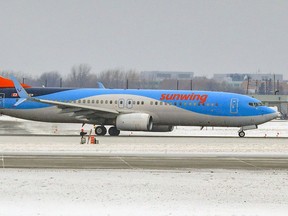 A Sunwing Boeing 737 aircraft taxis before taking off from Trudeau Airport in Montreal Thursday January 6, 2022.