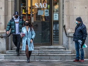 Two customers leave the SAQ store in Old Montreal on Jan. 6, 2022.