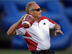 Montreal Alouettes defensive-coordinator Jeff Reinebold throws a football prior to a game against the Hamilton Tiger-Cats in Montreal in 2012.
