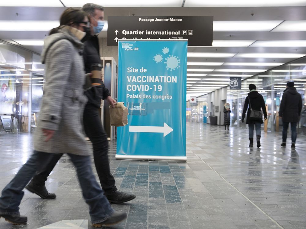 People make their way to the vaccination clinic at the Palais des Congrès on Saturday, January 8, 2022.
