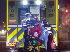 Paramedics wheel a COVID patient to an ambulance in Montreal this week.