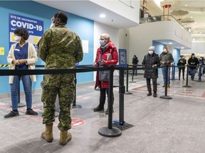 People make it to the head of the line at the COVID-19 vaccination clinic in Décarie Square in Montreal on Wednesday, January 12, 2022.