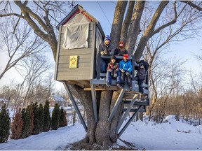Peter Ducree with neighbourhood kids Ben and Owen Pepin, front, and Emma and Sam Williams in the treehouse in his Pointe-Claire backyard. The city says the treehouse must come down because a part of it is on city property.