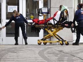 Paramedics bring a patient into the emergency room at the Notre-Dame Hospital in Montreal, on Thursday, January 13, 2022.