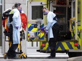 Paramedics transport a patient suspected of having COVID-19 to the special COVID section of the emergency room at the Notre-Dame Hospital in Montreal on Jan. 13, 2022.