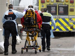 Paramedics transport a patient suspected of having COVID-19 to the special Covid section of the emergency room at the Notre-Dame Hospital in Montreal, on Thursday, January 13, 2022.