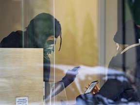 A security guard scans a vaccine passport at a Montreal cannabis store on Tuesday, January 18, 2022.