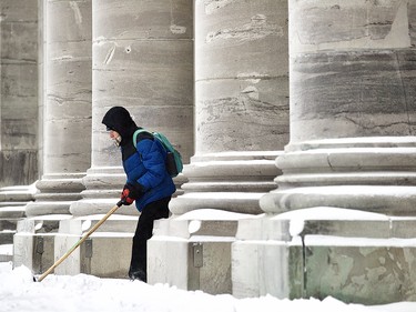 Volunteer Jean-Guy Legault clears snow, for the exercise, at Mary Queen of the World Cathedral in Montreal Jan. 17, 2022.