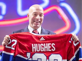 Kent Hughes holds a hockey jersey after a news conference introducing him as the Montreal Canadiens new general manager at the Bell Centre in Montreal Wednesday Jan. 19, 2022.