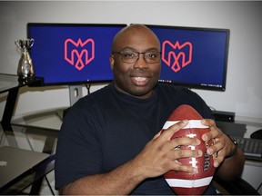 Alouettes director of pro personnel Jean-Marc Edmé, holds a 2010 Grey Cup football presented to him from his first stint with the Alouettes, at his home office in Ottawa on Jan. 16, 2022.