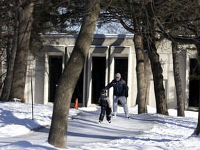 Jean-Sébastien Renault skates with his son, Mathis Renault, along paths near the Dorval library on Sunday.